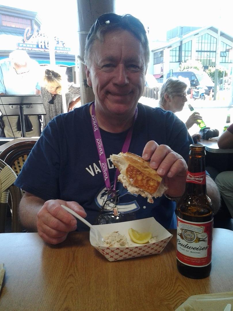 Enjoying a hunk of sourdough bread filled with crab meat on San Fransisco's fishermans wharf .
