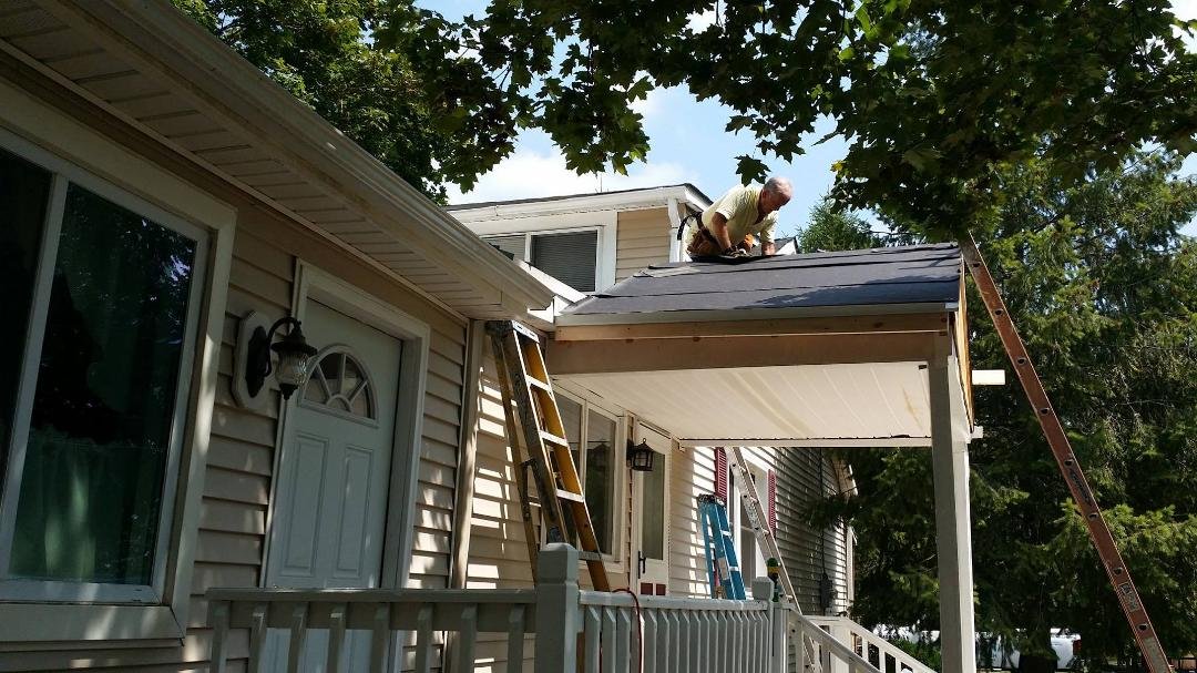 Mike putting shingles on the roof yesterday.