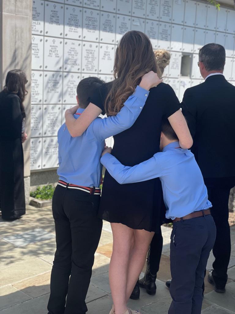This a heartwarming picture of Lucy our grandaughter with two of her cousins watching as I placed their Pams, Mags, Patricia urn into the vault. Lots of tears but lots of love too.