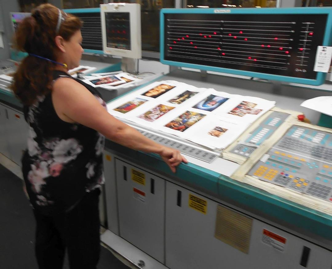 MARYANNE CHECKS THE COLOR CORRECTIONS FOR ANOTHER SET OF PAGES....