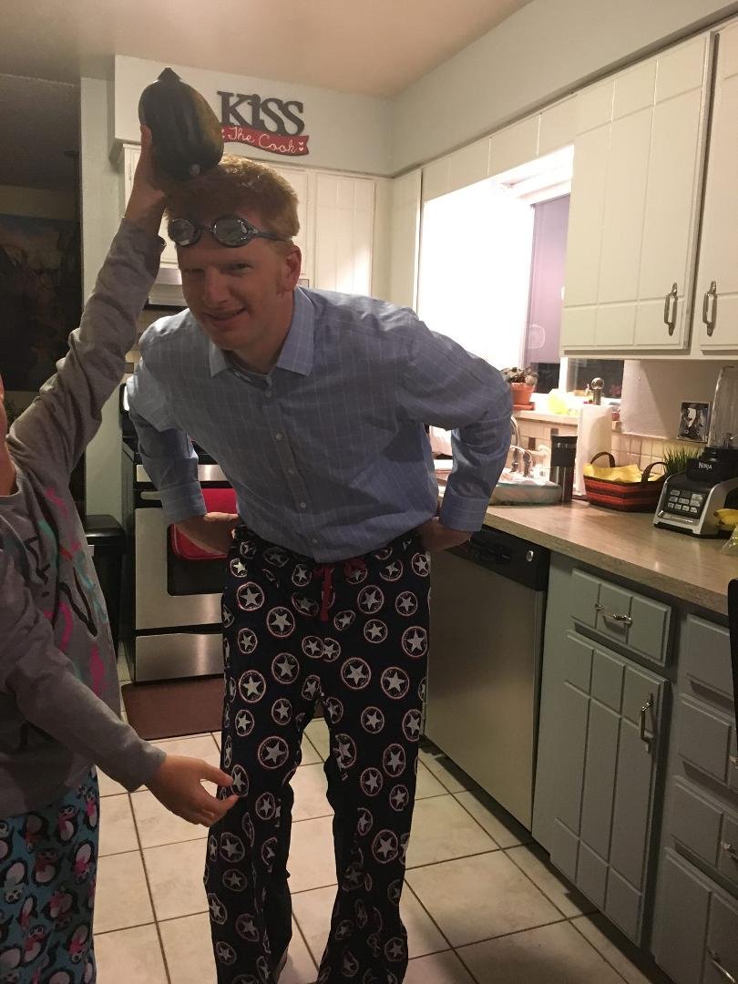 Ross with his birthday presents. A squash. Captain America pajama and swim goggles.
