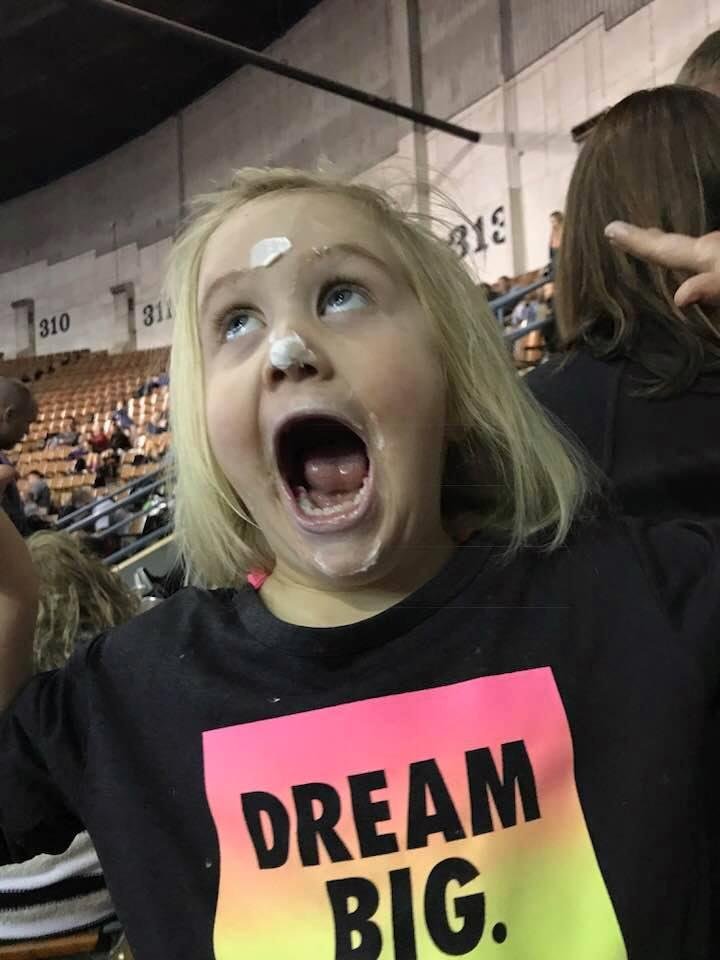 Birthday cupcake all over her face. She has been telling everyone she is 4 today. At the hotel this morning the worker gave her chocolate cake for her birthday