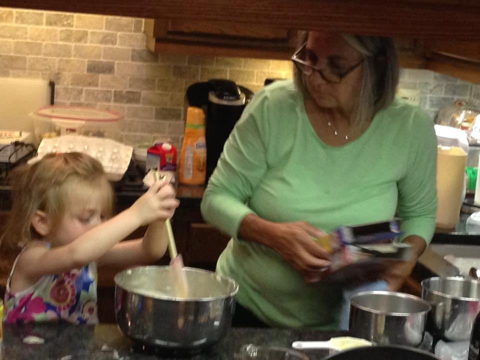 Cora helping Baba in the kitchen.