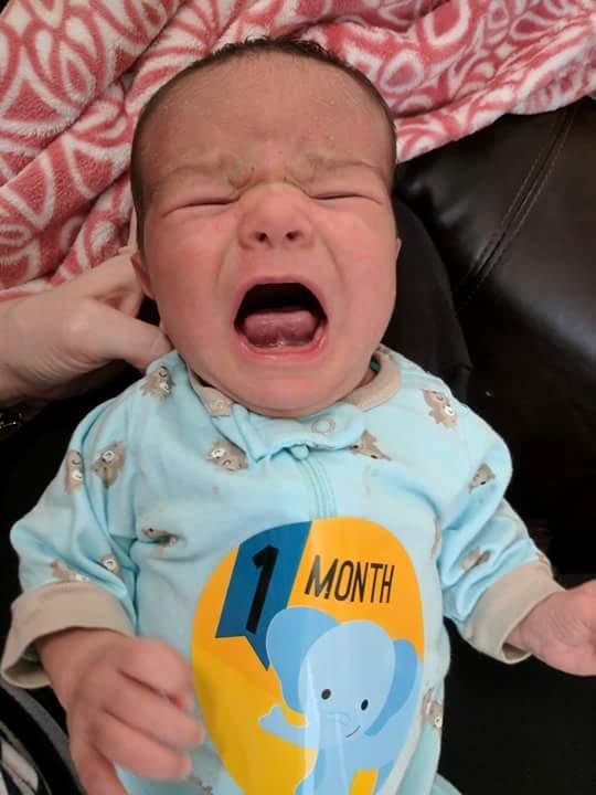 He's not to happy in his one month pic ! He was so happy the day before !!! 😊
