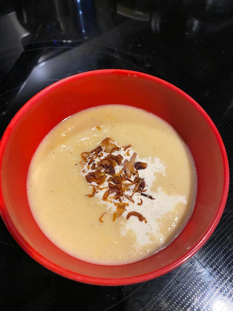 Rich cauliflower and cheddar soup complemented by crème fraîche and the crunch of fried shallots