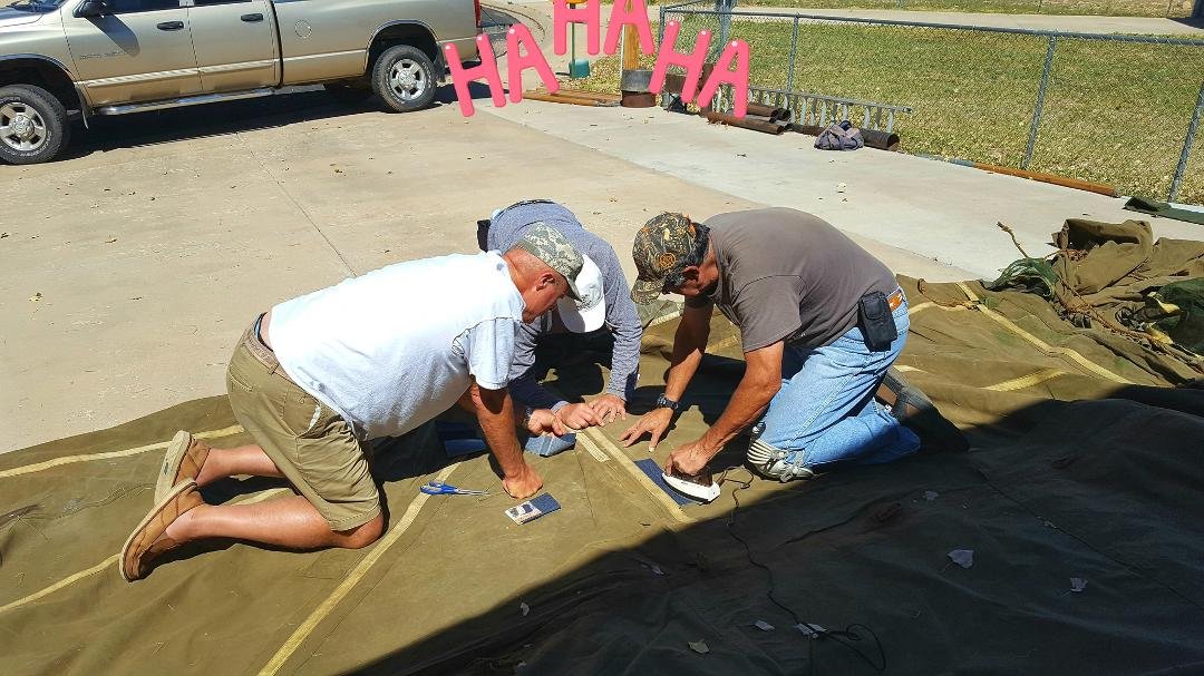 THE big hunters getting their new tent ready. Three stooges hard at work.