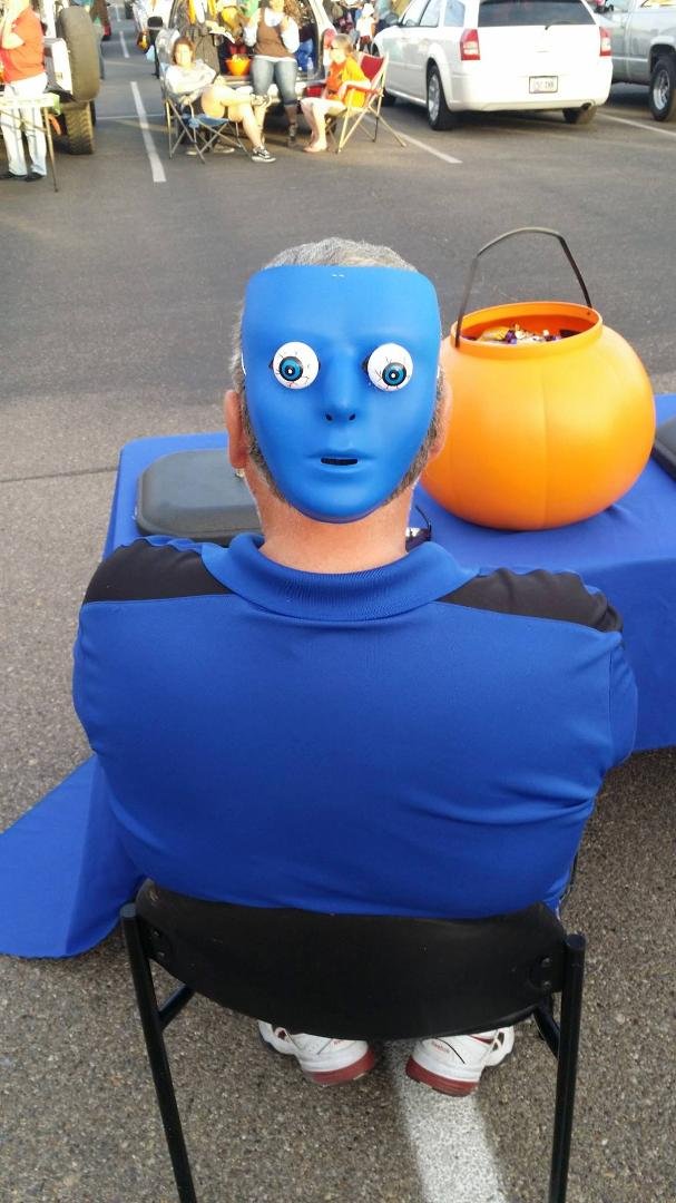 Passing out candy at trunk or treat for all the kids to have a safe place to go