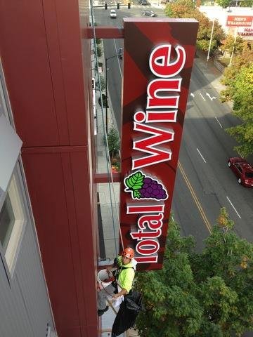 Dangling from ropes, washing windows.
