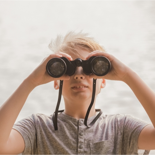 Little kid looking through binoculars