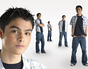 Boy standing in white room multiple times