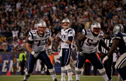 Quarterback Tom Brady, No 12, prepares to throw pass at Gillette Stadium, New England Patriots vs. Dallas Cowboys on October 16, 2011 in Foxborough, Boston, MA.