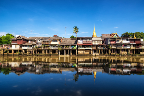 Village near river in morning with clear blue sky at chantaboon village in chantaburi , Thailand