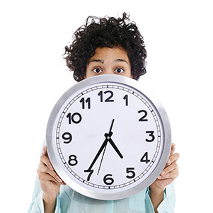 hispanic business woman hiding behind big watch 