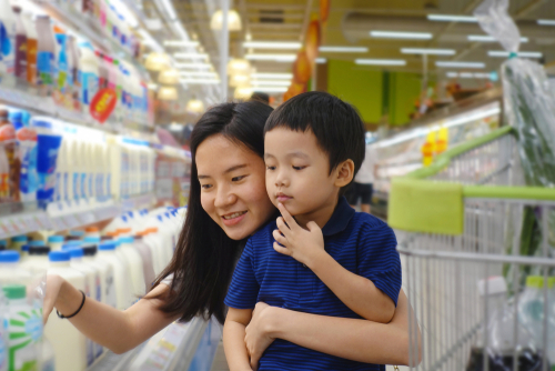 Mother and daughter doing shopping in grocery store