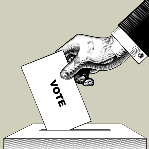 hand putting voting card into ballot box.