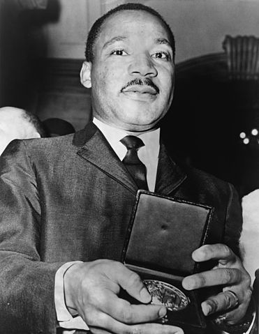 Martin Luther King, Jr. showing his medallion received from Mayor Wagner