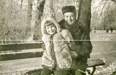 Vintage photo of a mother and daughter with a crease across the middle
