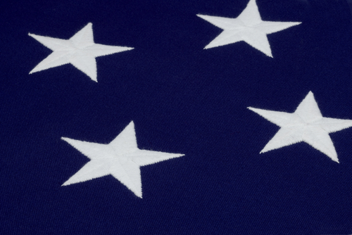 Close up shot of 4 hand sewn stars on an American flag