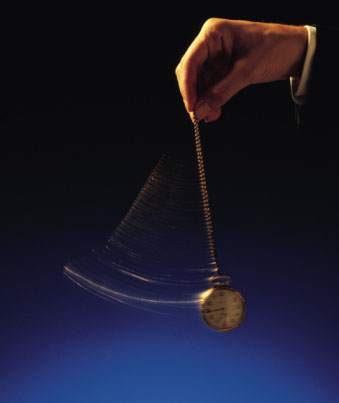 Hand of businessman swinging a pocket watch.