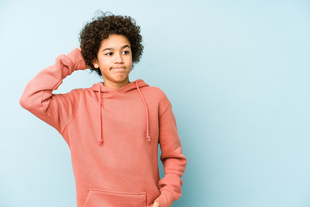 Young student thinking and scratching the back of their head.