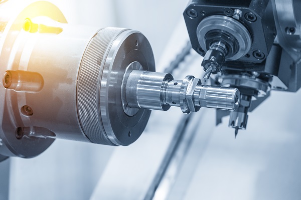 Turning machine drilling the metal rod with the drill tool and center drill toole