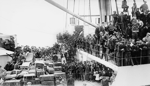 A crowd of European immigrants arriving in New York Harbor on June 19, 1913, with over 4,000 passengers, on the world's largest ocean liner.