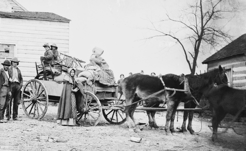 DEPARTURE FROM THE OLD HOMESTEAD, 1862 photograph by George Barnard shows a American family on the move during the Civil War. The pipe smoking woman may be a descendant of early Scotch-Irish settlers.