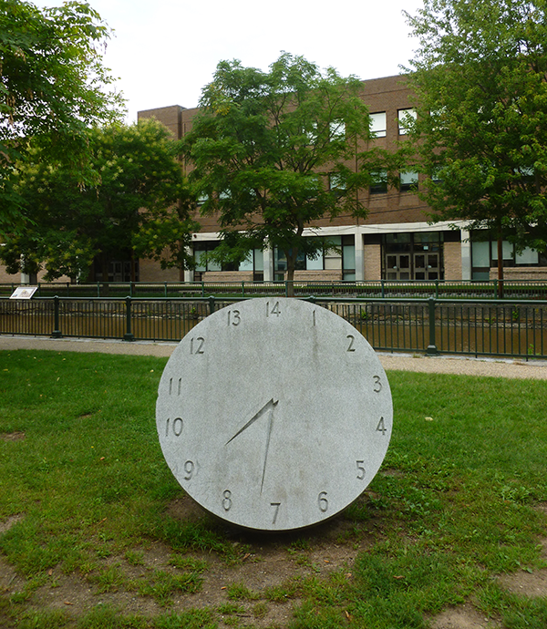 A 14-hour clock monument at Lucy Larcom Park, made by Ellen Rothenberg in 1996, memorializes the 10-hour movement of the early 1800s, spearheaded by female workers in Lowell, Massachusetts.
