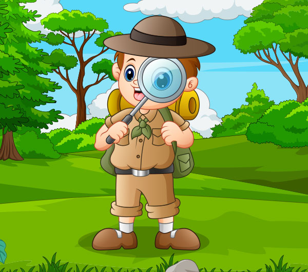 boy with magnifying glass in the woods