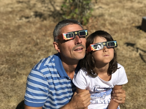 Father and daugher watching solar eclipse