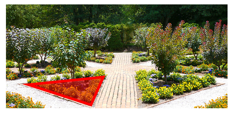 Triangle-shaped garden bed with red shading with red shading over the garden and a red border around the edges.