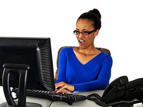 woman staring at computer screen in annoyance