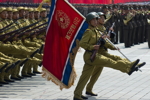 PYONGYANG, NORTH KOREA - CIRCA JULY 2013 : North Korean soldiers at the military parade in Pyongyang with the portrait of Kim Jonhg-Il of the 60th anniversary of the conclusion of the Korean War.