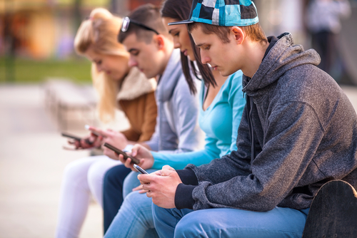 Group of teens on their smartphones