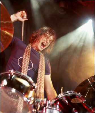 Man on drum set making noise