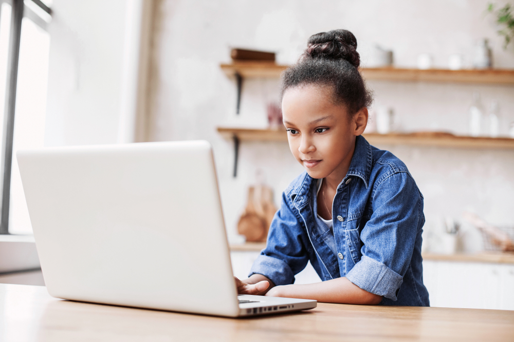 Girl using a laptop at home.