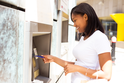 young woman at an ATM machine