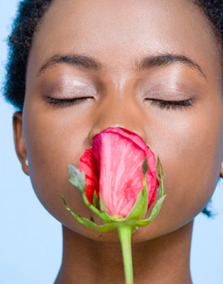 girl smelling a rose