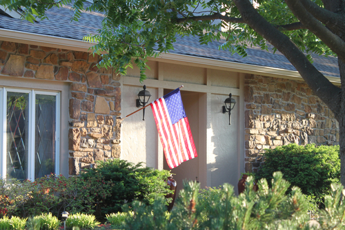 A nice house with a large American flag