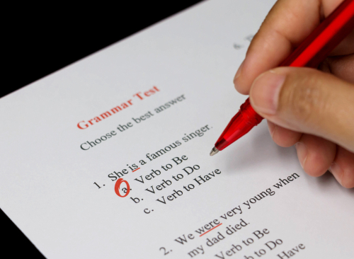 English grammar test sheet on black table