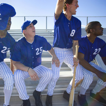 baseball players on the sidelines resting and cheering