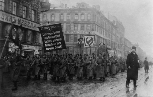 Russian Revolution. Funeral of 182 persons killed by Czarist police on Feb. 26, 1917. Crowd with banners in the street, St. Petersburg, Russia.