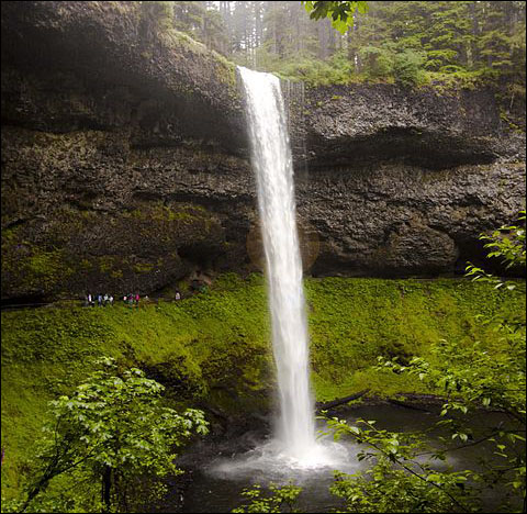 The State of Oregon waterfall with students hiking.