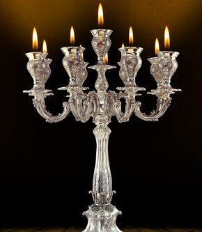 Silver Candelabra lighting up dark background.