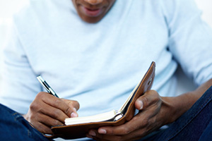 Man writing in notebook
