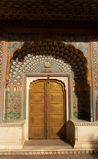 Take a close look at this doorway. There are several beautiful patterns that repeat all around the door. One looks like peacock feathers stacked one on top of the other. Can you see any other patterns?