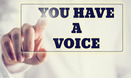 finger pushing a button that reads You have a voice