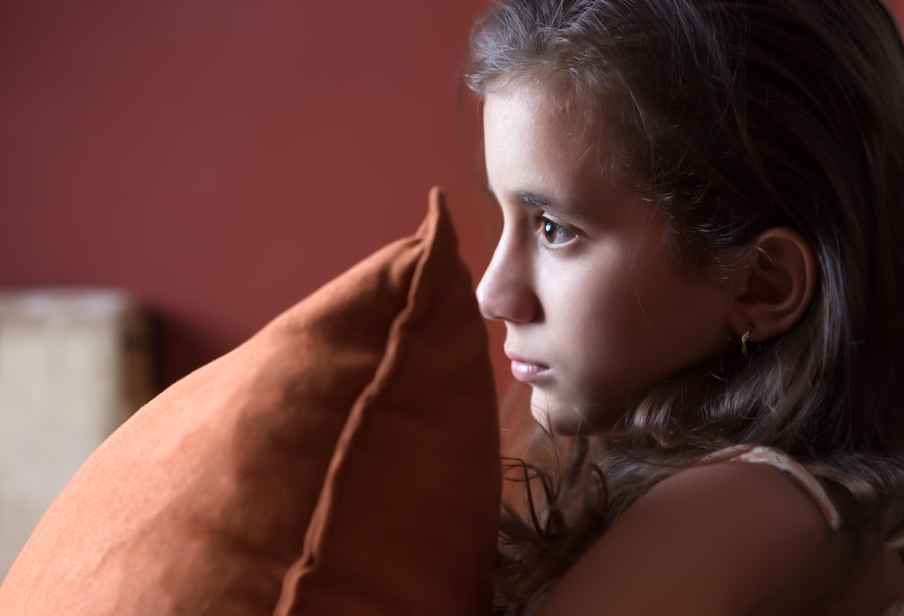 Young girl watching television late at night.