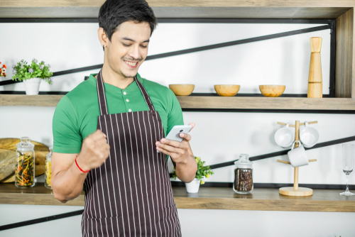 A young man looking at his order for Juice. Use enter key to open full-screen view.