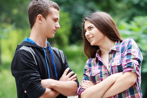 Girl arguing and joking with boy in the park.